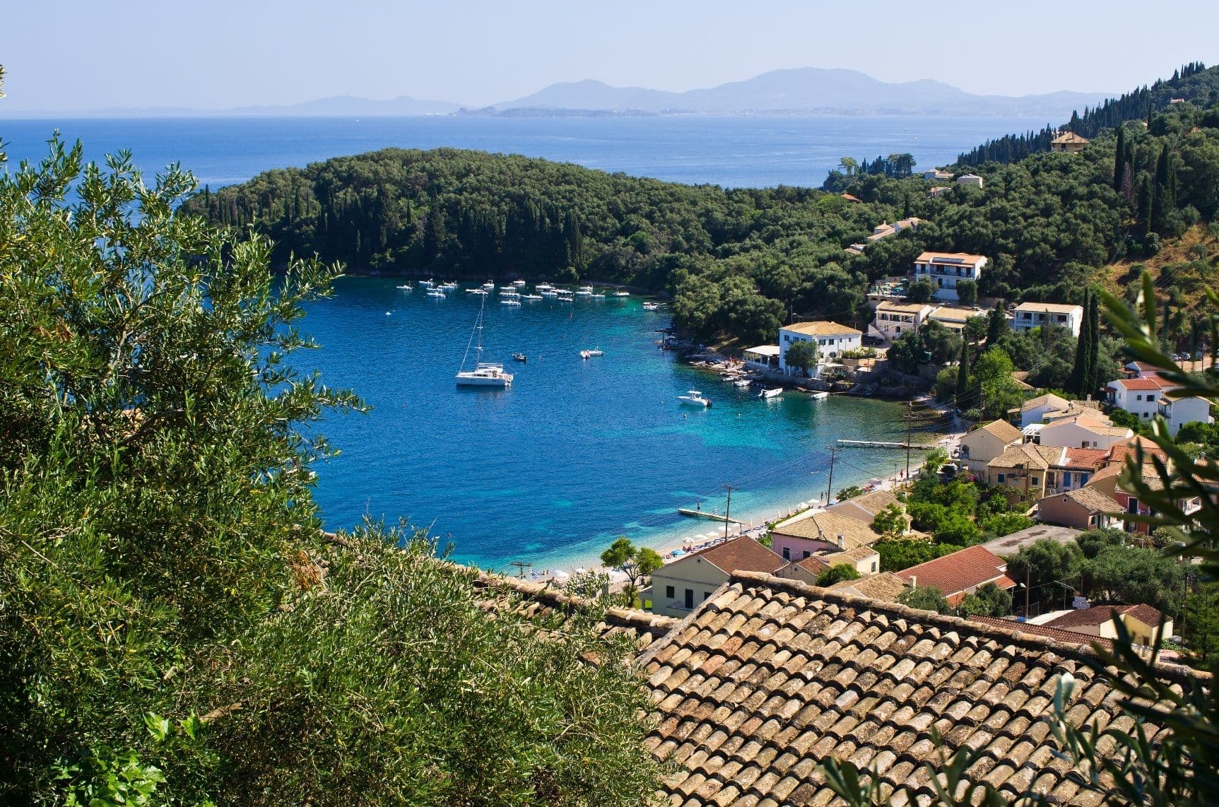 paxos yachts moored in bay town houses