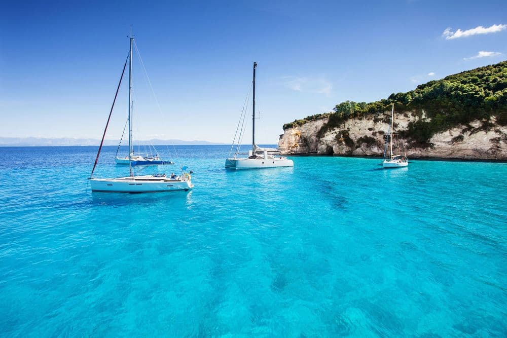 paxos greece boats moored near land blue water