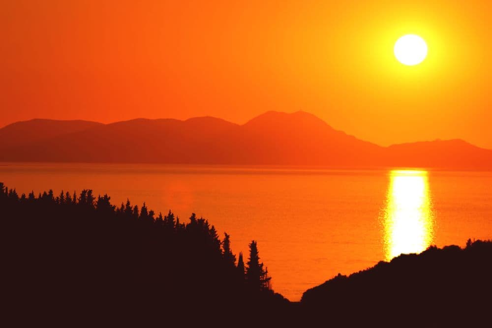 sivota islands red sunset over water