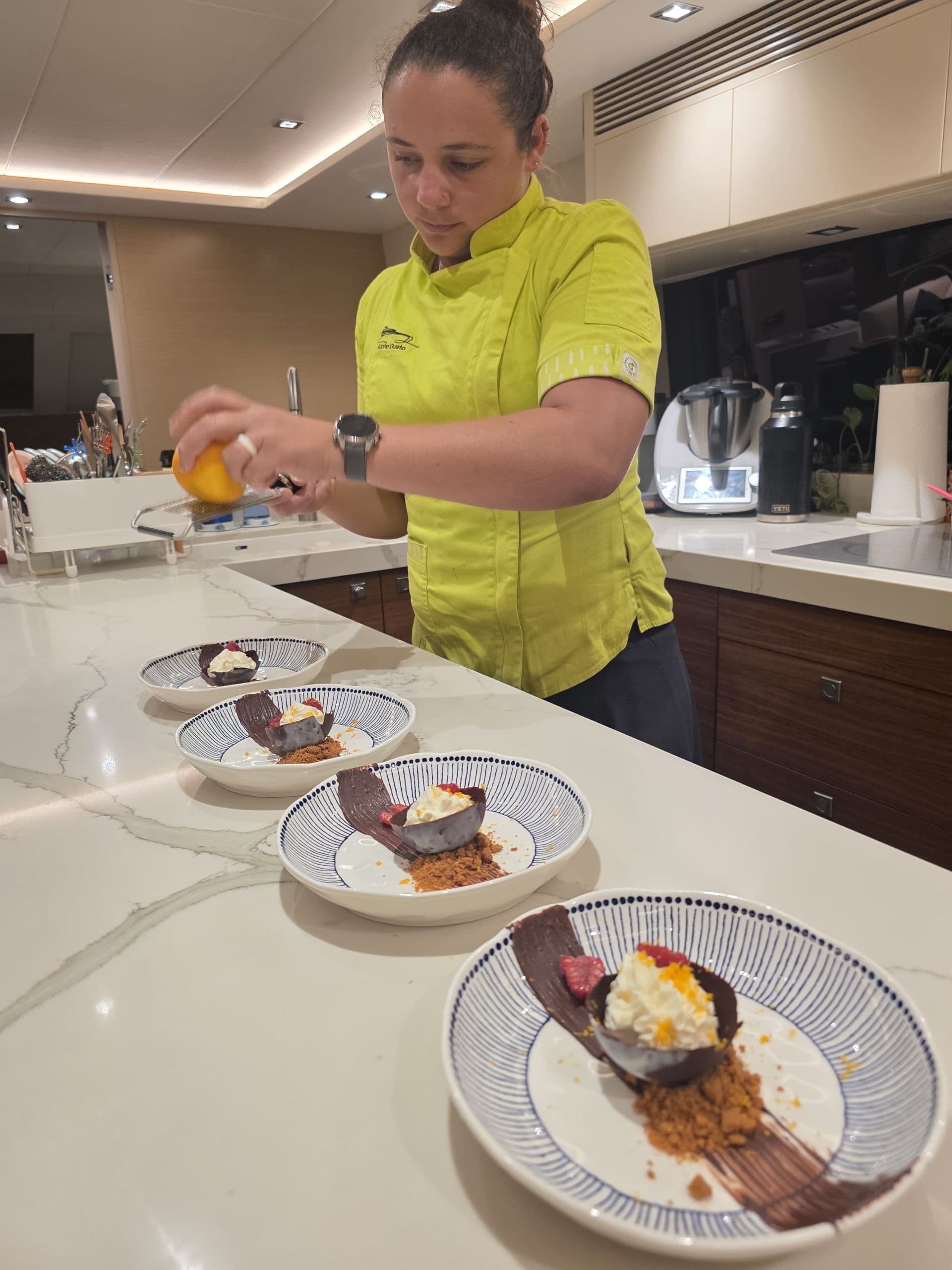 Chef Gi in her element busy serving guests yet another delicious finale to dinner
