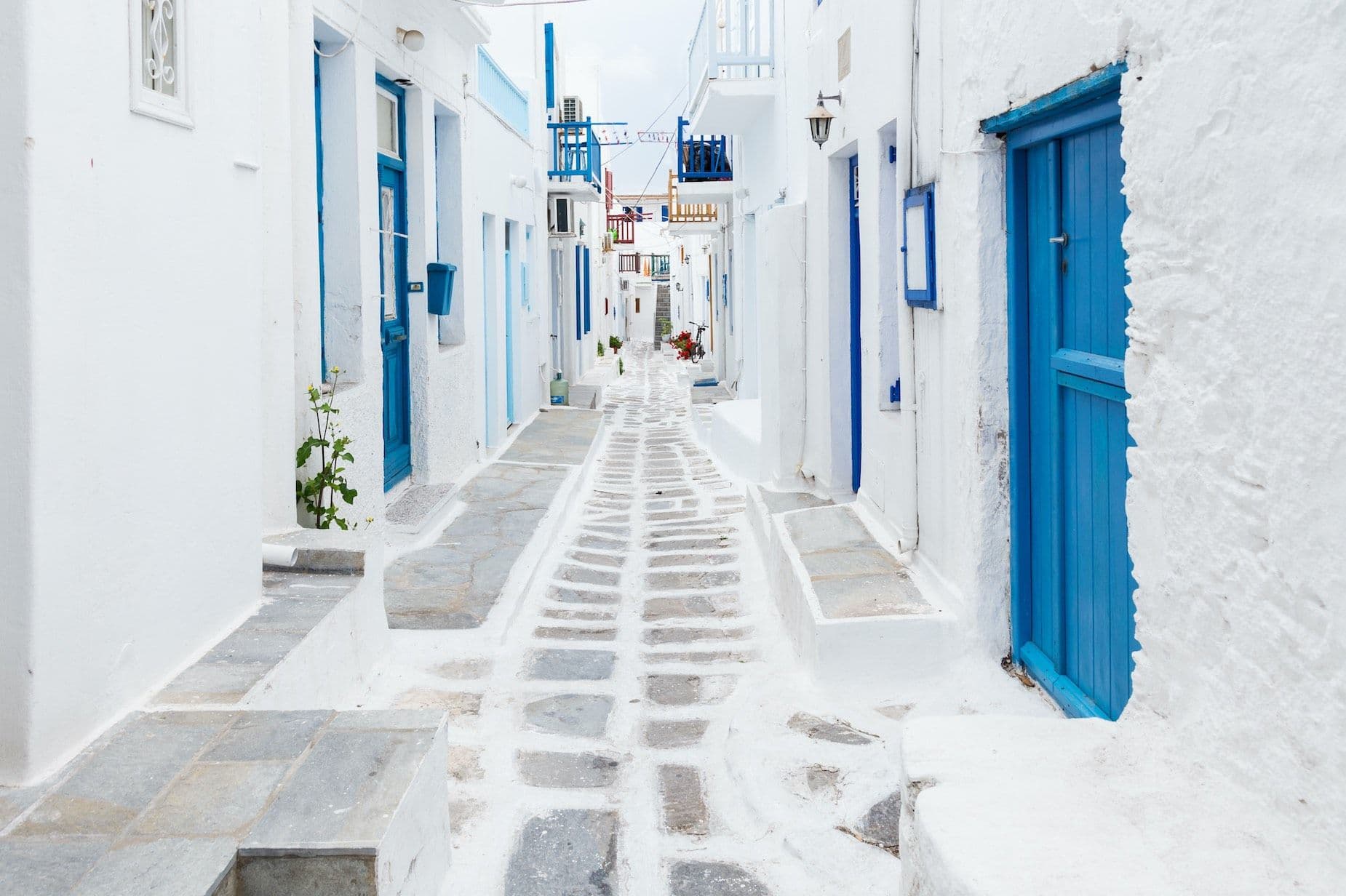 cyclades white path with blue doors greece