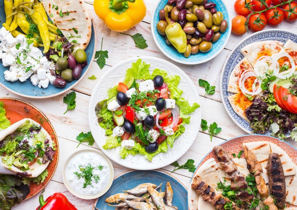 greek cuisine salad and dishes on table