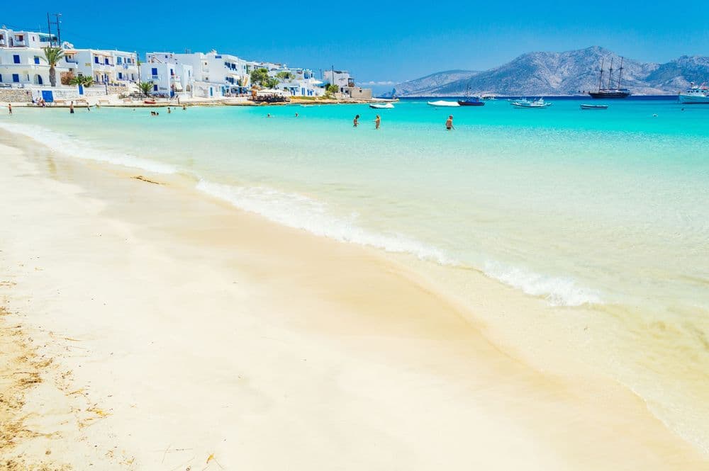koufonisia beach people in distance houses sand clear water greece