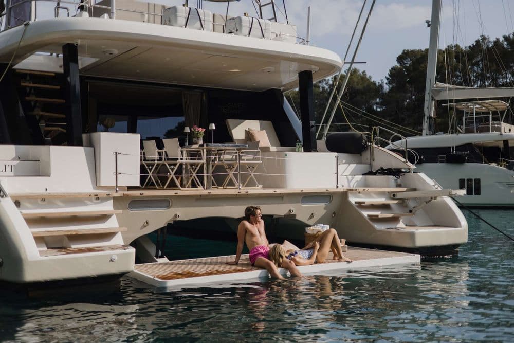 sunreef 50 sweet dreams couple sitting back deck crewed