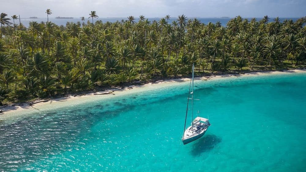 remote caribbean anchorage with beach and trees