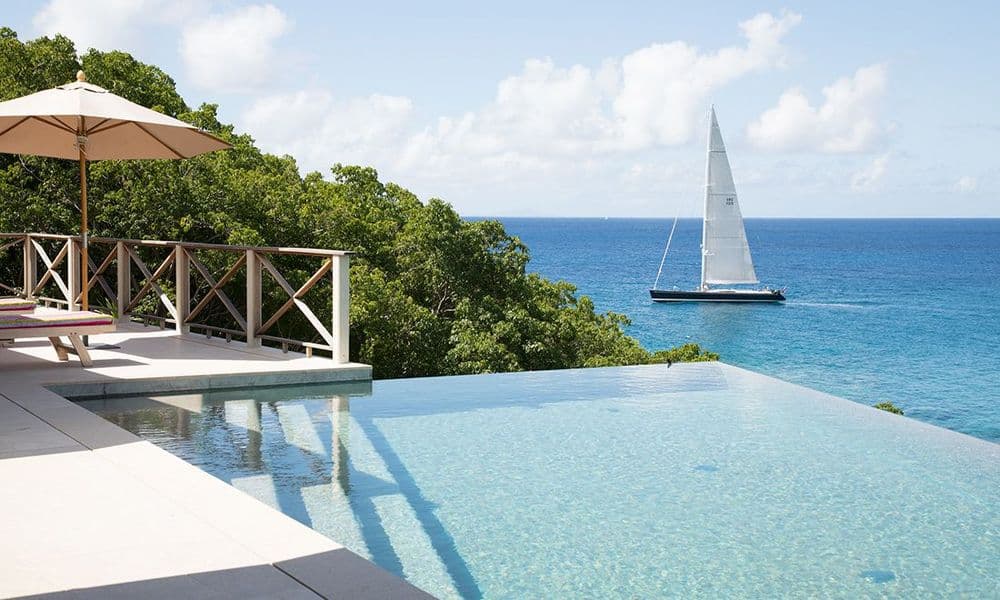 antigua villa with infinity pool yacht in back