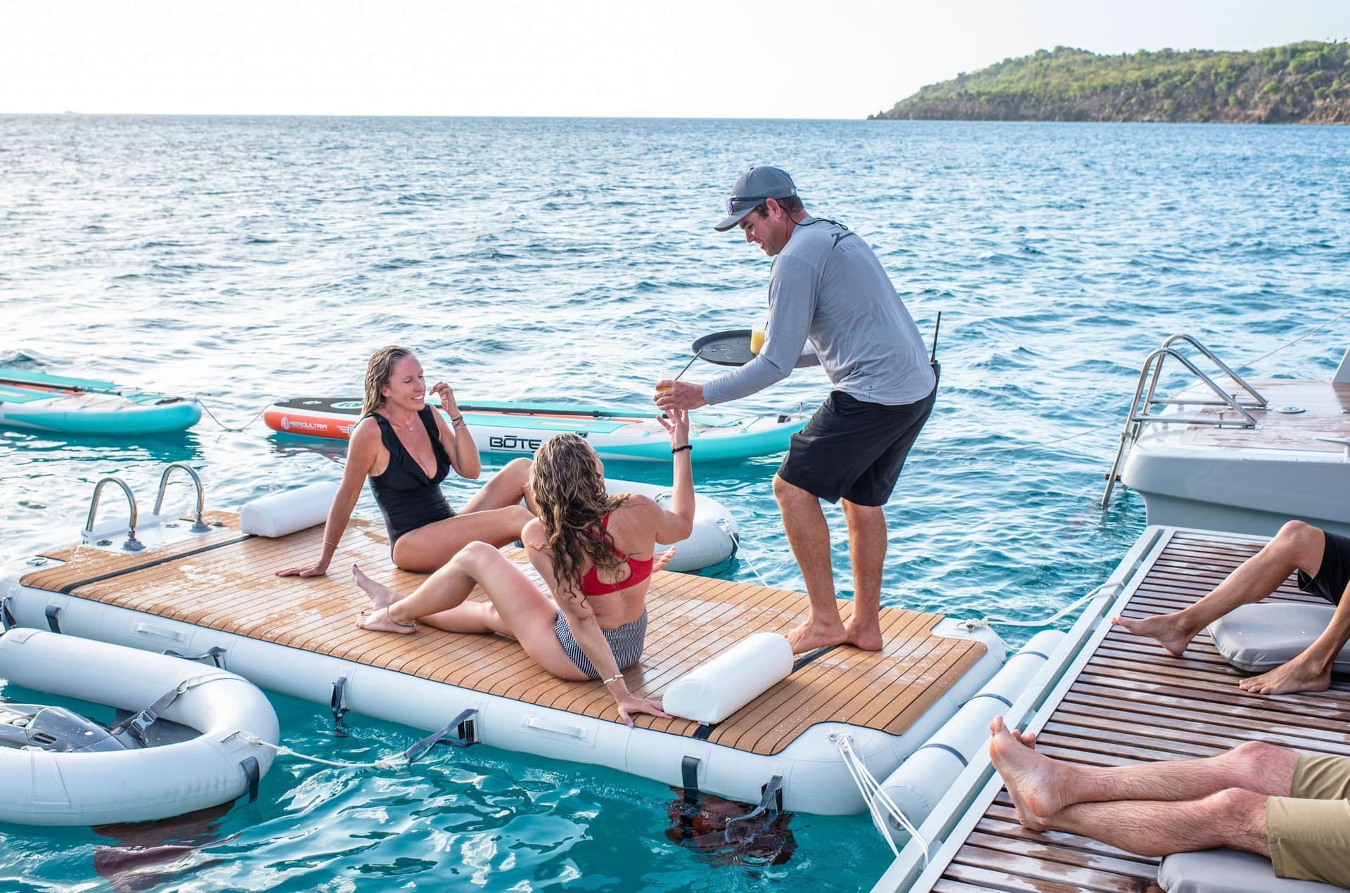 deckie handing out drinks crewed catamaran BVI