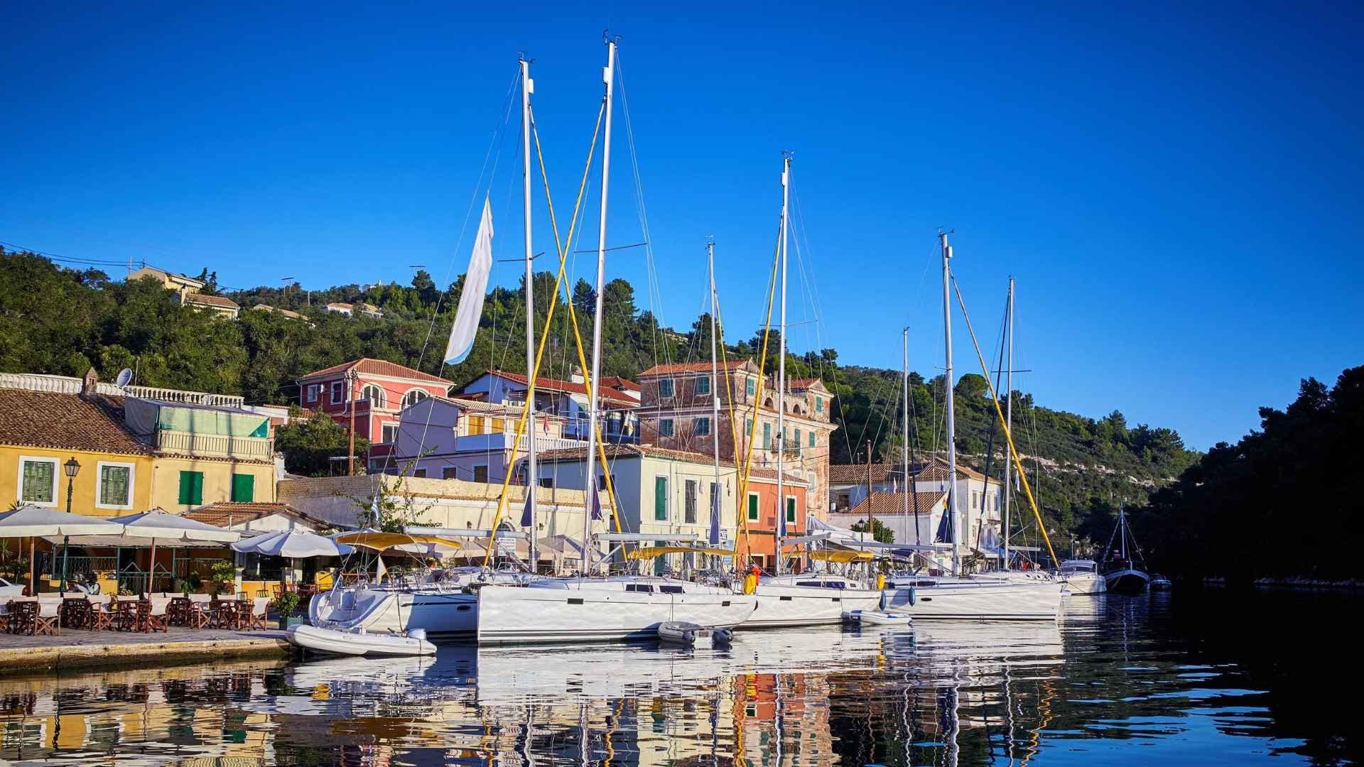 paxos yachts moored in bay town houses