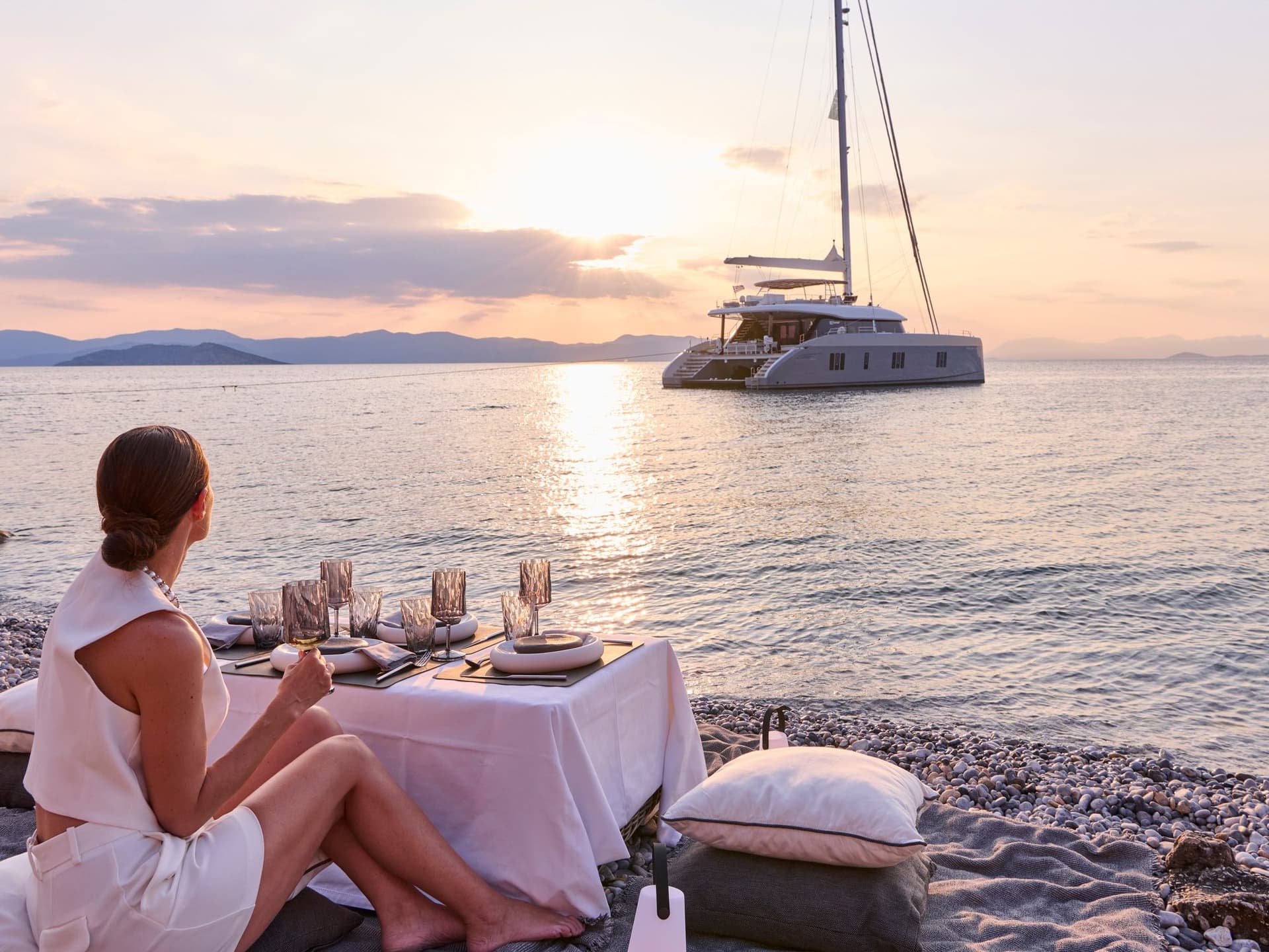 above and beyond excursion woman wine beach boat sunset