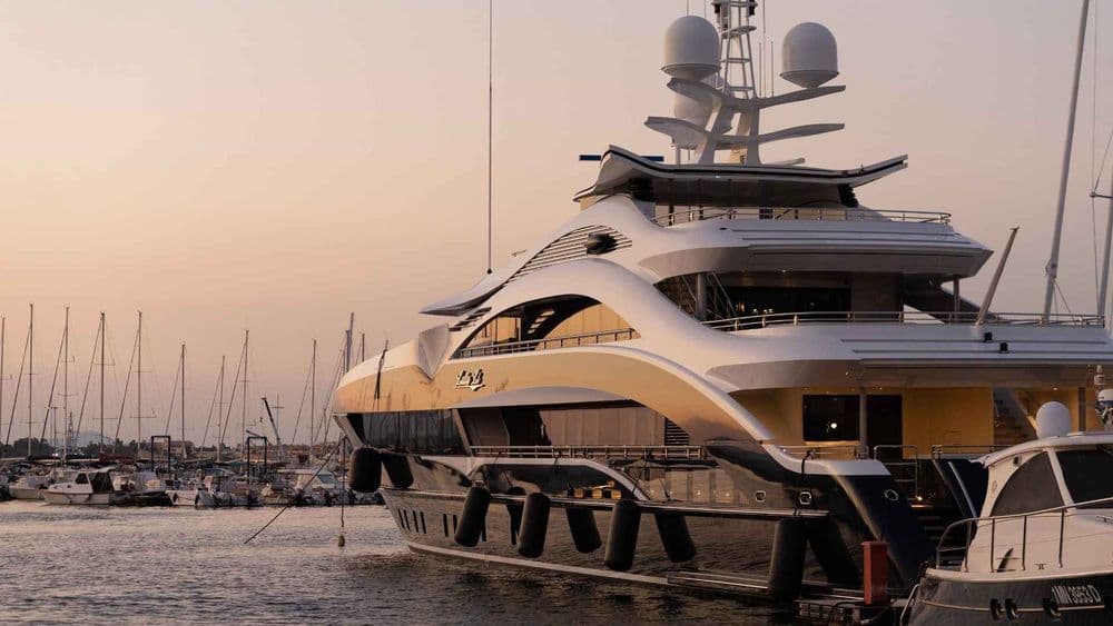superyacht moored at dusk pink sky