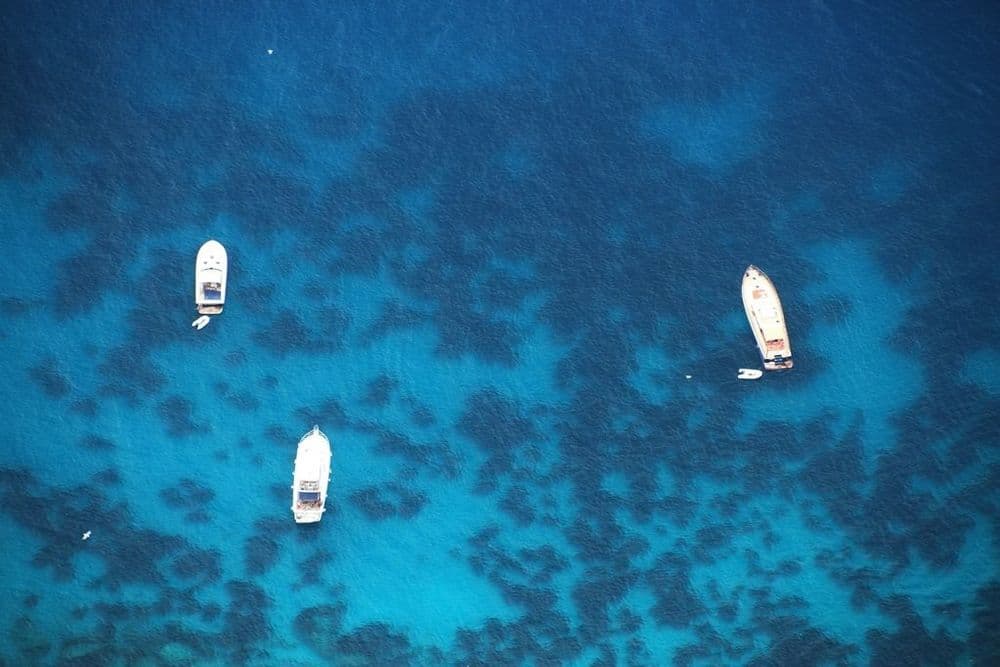Three Boats in Blue Water