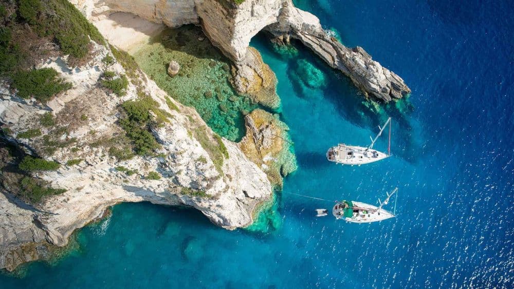paxos greece boats moored near land blue water