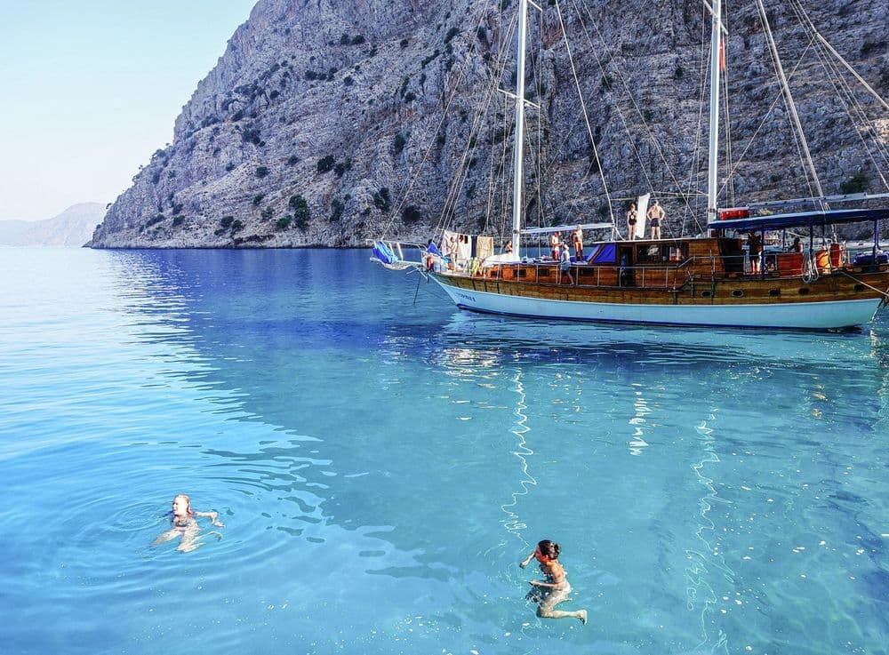 people-swimming-in-the-water-near-gulet