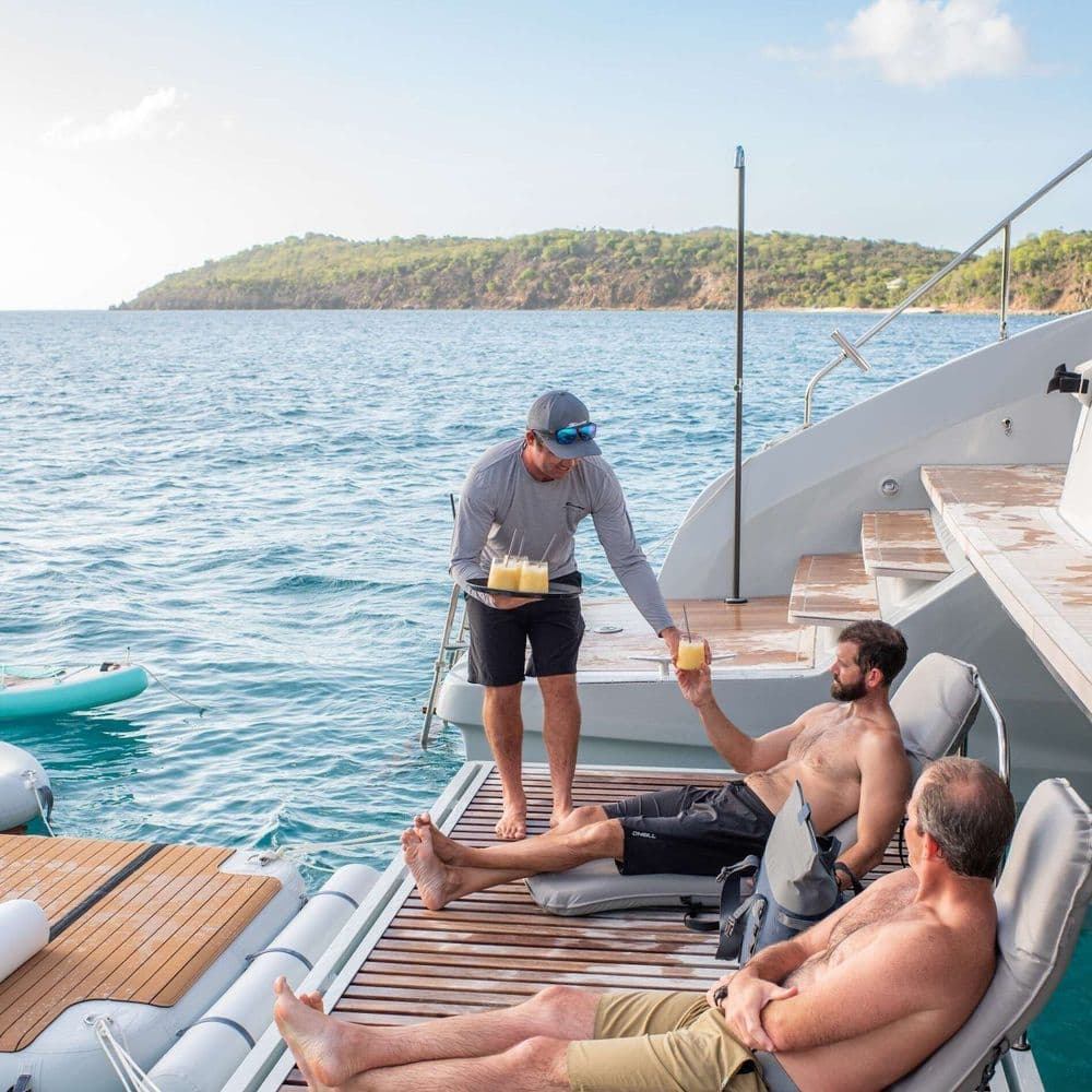 captain-robbie-serving-drinks-lagoon-67-power-catamaran-BVI