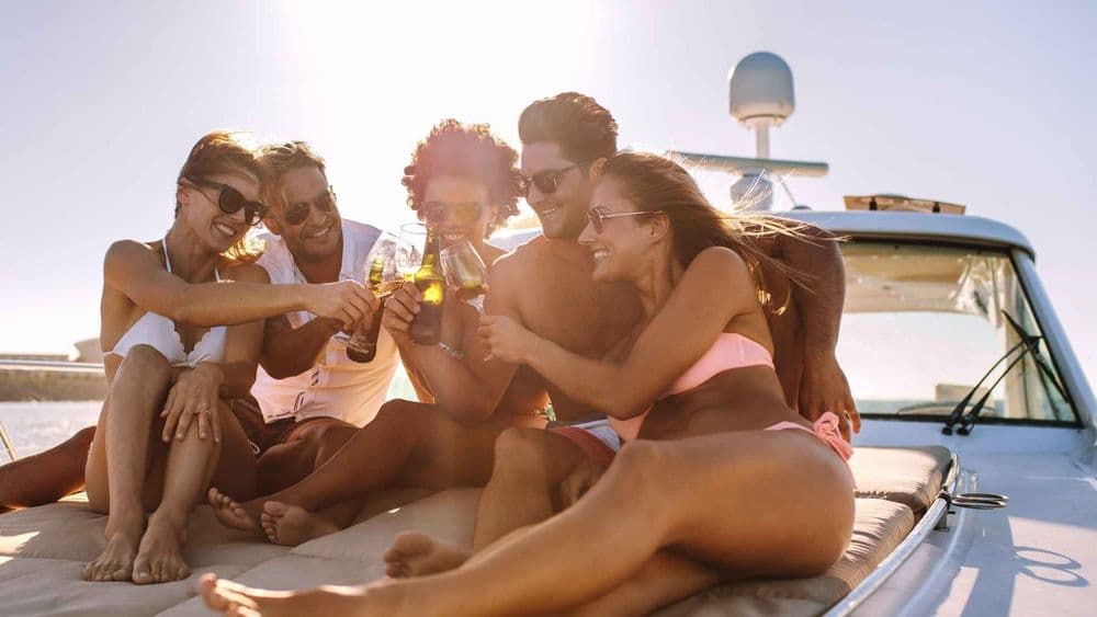friends on the bow drinks cheers lifestyle