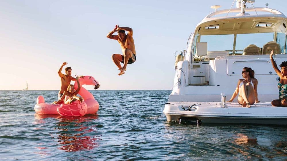 jumping off powerboat inflatable pink flamingo